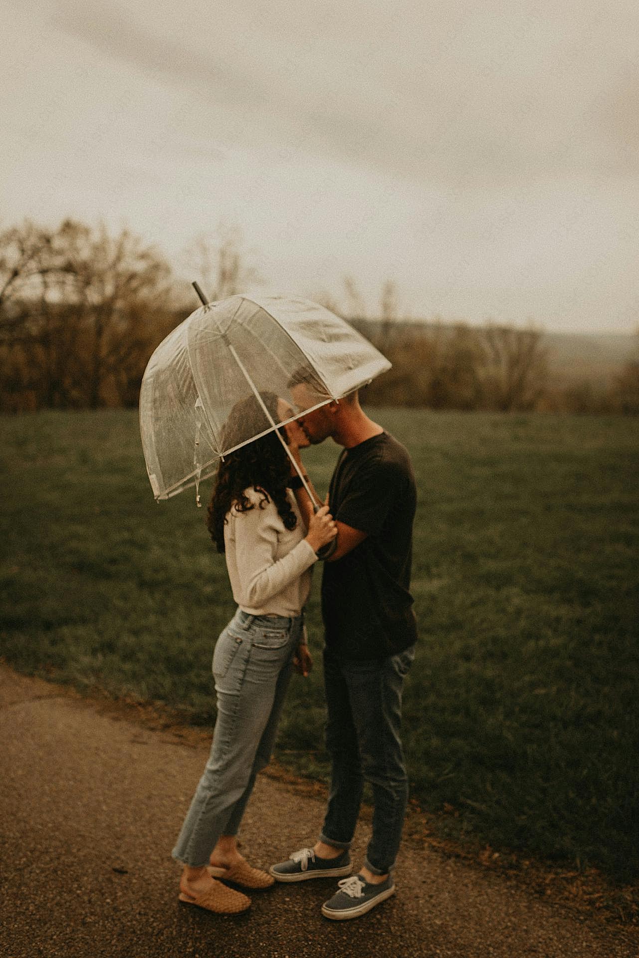雨中情侣撑伞接吻图片高清摄影